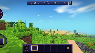 A phone held sideways in a world, edge to edge: sunlit grass and a sandy shore, the stick, the hotbar and the compass.